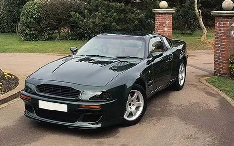 Dark green sports coupe parked in a driveway